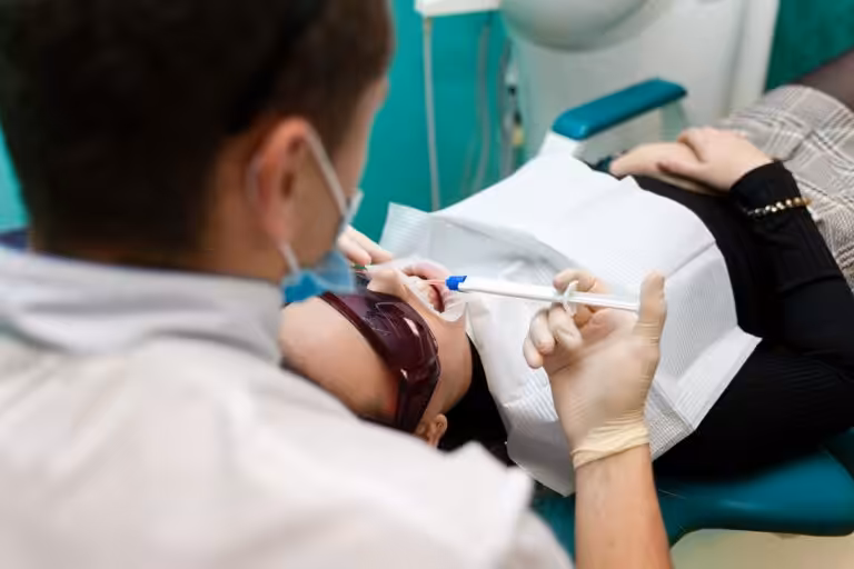 Dentist performing a preventive dental examination on a patient in Apex NC