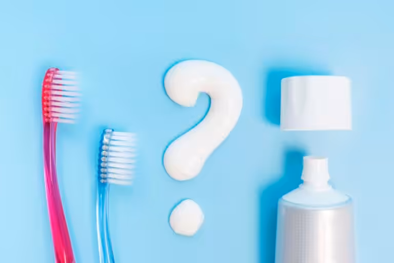 Person choosing a toothbrush and fluoride toothpaste for daily oral care